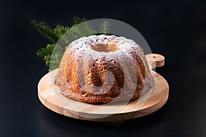 Food Concept homemade Gugelhupf, Guglhupf, Kugelhopf, kouglof bundt yeast cake of Central Europe on black background