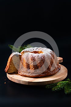 Food Concept homemade Gugelhupf, Guglhupf, Kugelhopf, kouglof bundt yeast cake of Central Europe on black background