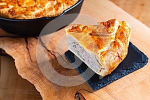 Food concept homemade pork pie or meat pie on stone plate and ca