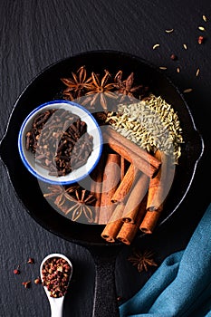 Food concept origin Chinese Five Spice  Star Anise, Fennel Seeds, Szechuan Peppercorns, Whole Cloves and Cinnamon Stick on black