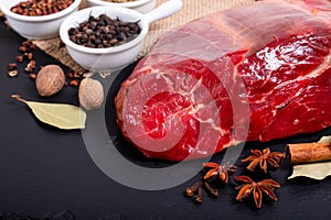 Food concept Picece of shank beef on black slate stone and various spice with copy space