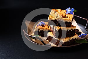 Food concept rustic Brookies or Crownies combine cookies and brownie on black background with copy space