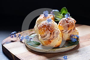 Food concept Spot focus homemade Choux puff Praline on black background with copy space