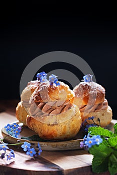 Food concept Spot focus homemade Choux puff Praline on black background with copy space