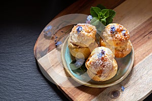 Food concept Spot focus homemade Choux puff Praline on black background with copy space