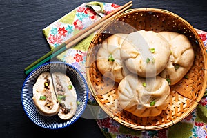 Food concept spot focus homemade organic dim sum Baozi, or bao pork Chinese Steamed Buns on black background with copy space