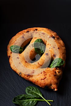 Food concept  traditoin French Fougasse artisan flatbread on black slate board with copy space