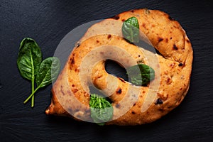 Food concept  traditoin French Fougasse artisan flatbread on black slate board with copy space