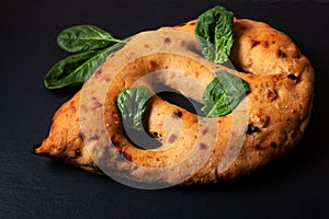 Food concept  traditoin French Fougasse artisan flatbread on black slate board with copy space