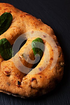Food concept  traditoin French Fougasse artisan flatbread on black slate board with copy space