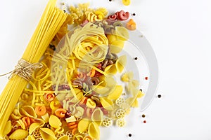 Food concept - various uncooked, raw Italian pasta, spread pepper peas on white background, top view, place for text, set