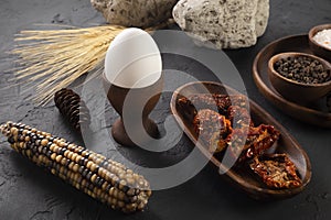 Food concept with wooden presentation board on black stone floor