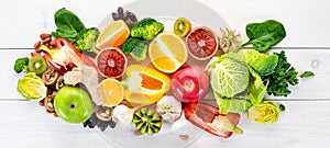 Food containing natural vitamin C: Orange, lemon, apple, rose, garlic, broccoli, apple, kiwi, spinach. Top view.