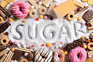 Food containing sugar. mix of sweet donuts, cakes and candy with sugar spread and written text in unhealthy nutrition, chocolate