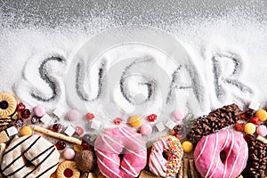Food containing sugar. mix of sweet donuts, cakes and candy with sugar spread and written text in unhealthy nutrition, chocolate