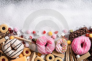 Food containing sugar. mix of sweet donuts, cakes and candy with sugar spread and written text in unhealthy nutrition, chocolate