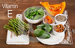 Food containing vitamin E on wooden table.