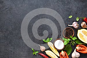 Food cooking background on black table. Fresh vegetables, spices, herbs. Ingredients for cooking with space for text