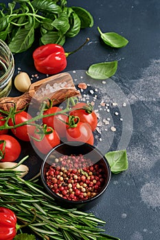 Food cooking background. Fresh rosemary, cilantro, basil, cherry tomatoes, peppers and olive oil, spices herbs and vegetables at