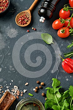 Food cooking background. Fresh rosemary, cilantro, basil, cherry tomatoes, peppers and olive oil, spices herbs and vegetables at