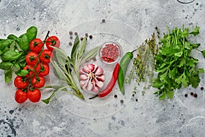 Food cooking background. Fresh saffron, garlic, cilantro, basil, cherry tomatoes, peppers and olive oil, spices herbs and