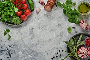 Food cooking background. Fresh saffron, garlic, cilantro, basil, cherry tomatoes, peppers and olive oil, spices herbs and