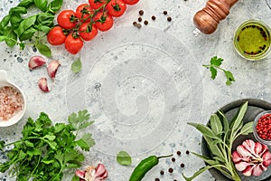 Food cooking background. Fresh saffron, garlic, cilantro, basil, cherry tomatoes, peppers and olive oil, spices herbs and