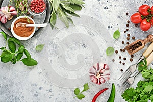 Food cooking background. Fresh saffron, garlic, cilantro, basil, cherry tomatoes, peppers and olive oil, spices herbs and