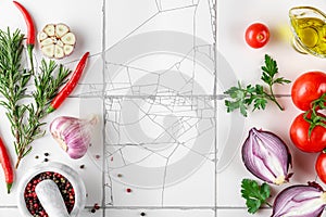 Food cooking background. Spices, vegetables and herbs on a rustic white tile kitchen table. Top view with copy space