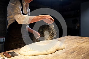 Chef or baker making bread dough at bakery