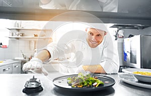 Happy male chef cooking food at restaurant kitchen