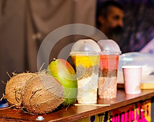 Food court/exotic fruits. Coconut with mango and smoothes. Healthy cocktails. Selling outdoor. Raw vegan diet. Healthy l detoxx photo