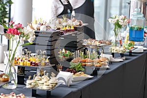 Food court. A set of catering dishes, food on a black plate.