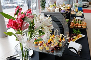 Food court. A set of catering dishes, food on a black plate.