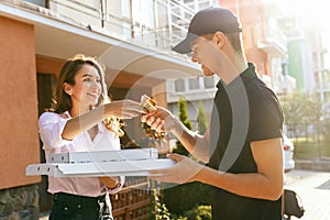 Food Delivery. Courier Delivering Pizza To Client Home