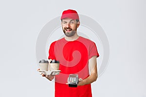 Food delivery, quarantine, stay home and order online concept. Cheeky courier in red uniform cap and t-shirt, wink to