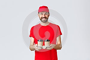 Food delivery, quarantine, stay home and order online concept. Smiling courier in red cap and t-shirt bring coffee to