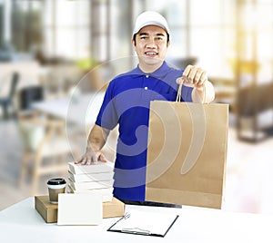 Food delivery service or order food online. Man holding paper ba