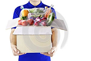 Food delivery service for order online grocery shopping concept. Delivery man in blue uniform hand holding paper box package.