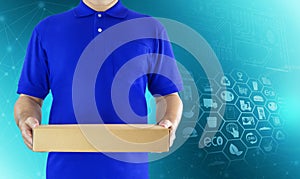 Food delivery service for order online shopping and icon media symbol. Delivery man in blue uniform hand holding paper box package