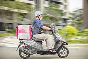 Food delivery staff ride motorcycles to deliver food