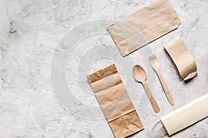 Food delivery workdesk with paper bags and flatware table background top view mock-up