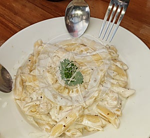 Food Dish : Pasta Alfredo with a group of friends sharing the plate