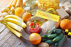 Food donation background with food assortment on the wooden table
