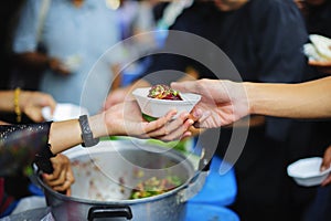 Food donation: The hands of the hungry are receiving food from the service provider