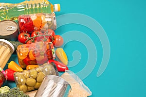 Food donations and different groceries on blue background with copy space - pasta, vegatables, canned food, baguette