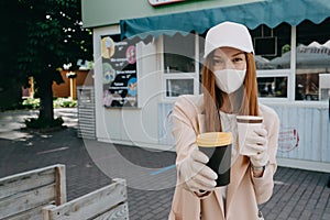 Food and drink businesses during coronavirus pandemic. Coffee to go takeaway cup in female hands in gloves. Restaurants