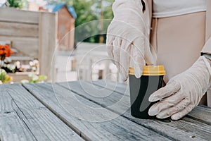 Food and drink businesses during coronavirus pandemic. Coffee to go takeaway cup in female hands in gloves. Restaurants