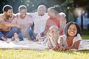 Food, drink and a family picnic in park with kids, parents and grandparents. Men, women and children relax outdoors in