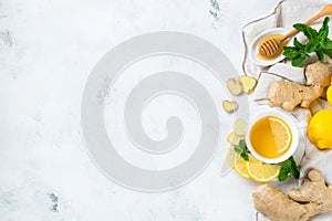 Food and drink, still life health care concept. Ginger tea infusion beverage in white cup with lemon mint honey on a kitchen table